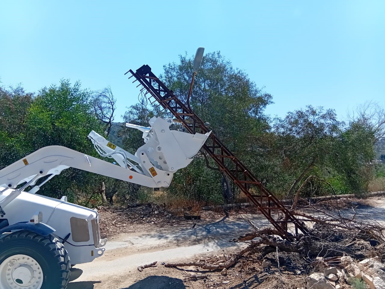 Heavy machinery removing cables and a  lighting tower