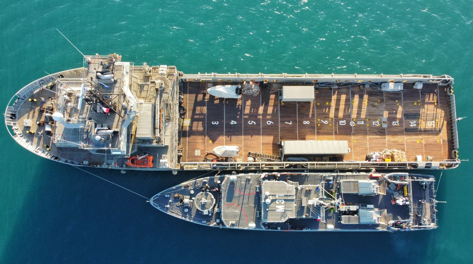Minehunter M-31 'Segura' docked to its command vessel for fuel supply