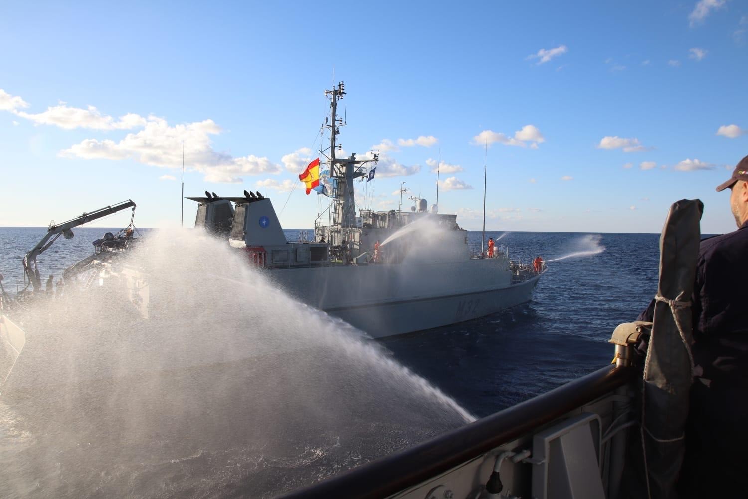 The Sella performing a farewell flypast with the minehunter Crotone