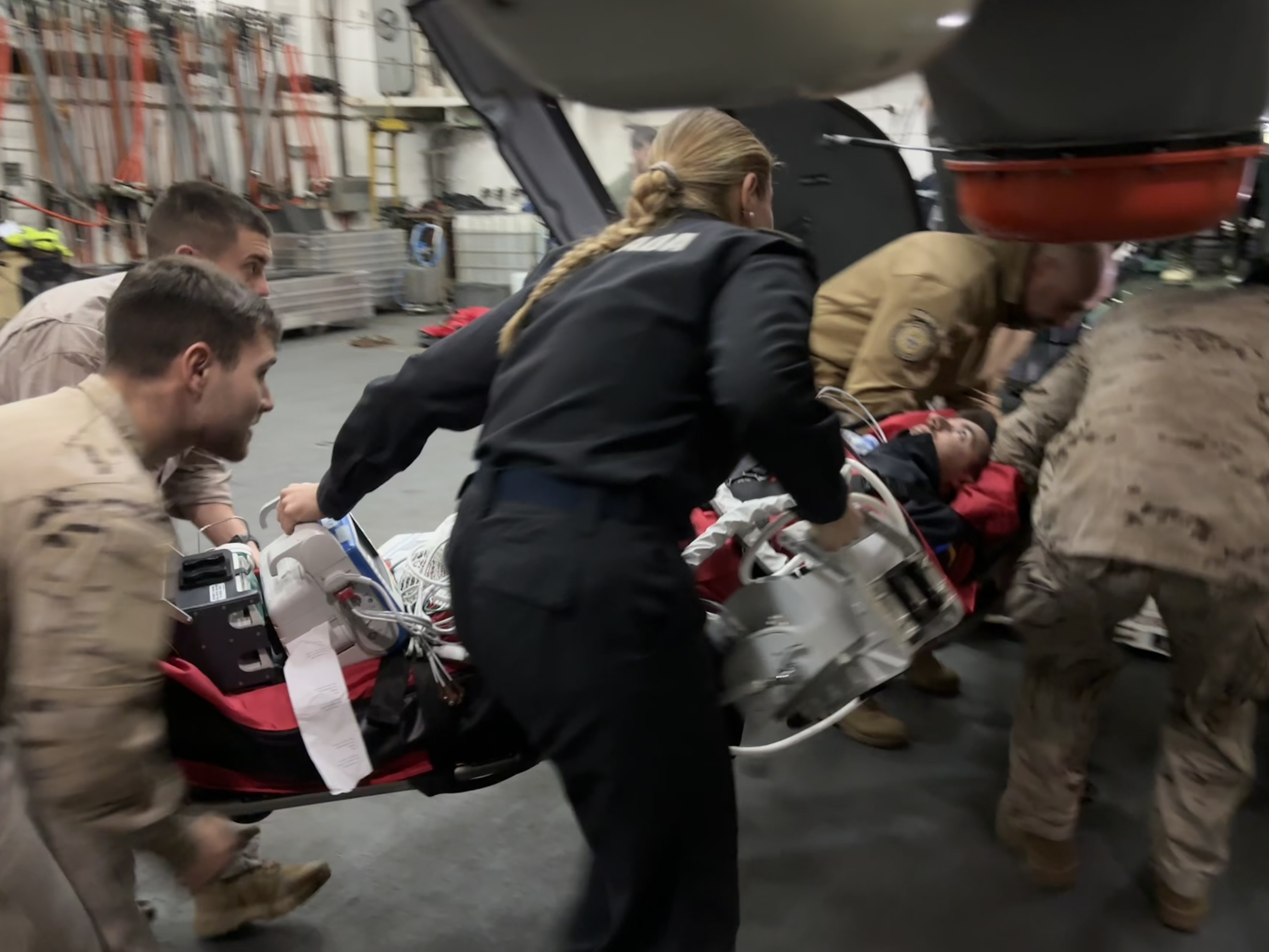 Stretcher transfer procedures carried out by the warship’s crew