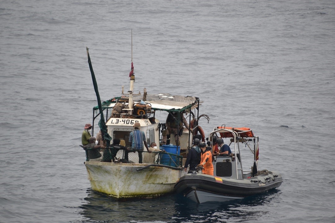 Vigia's crew next to the fisihing boat