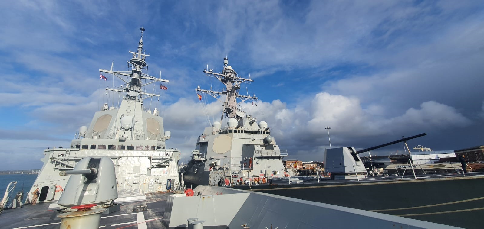 The frigate and the aircraft carrier in port