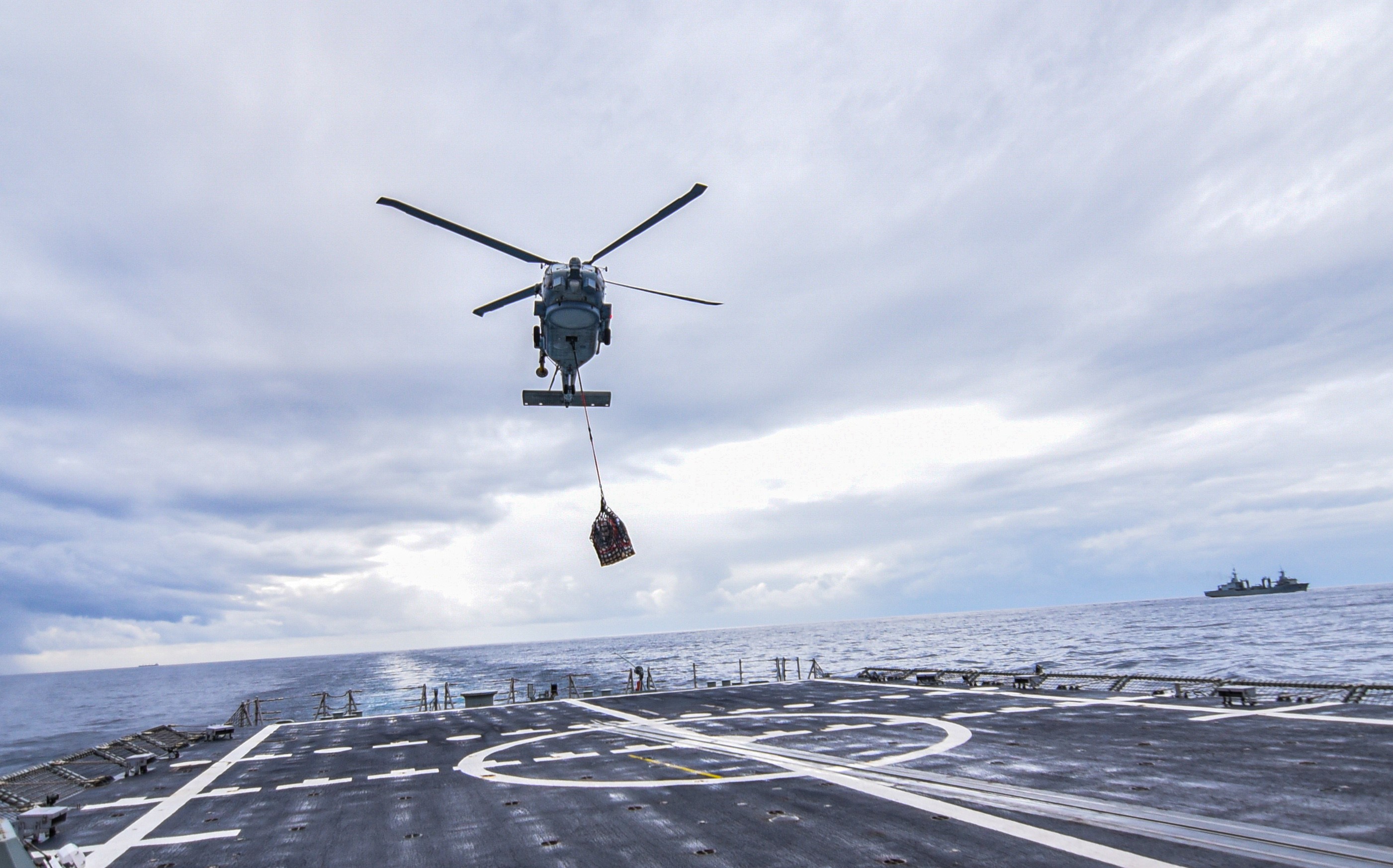 Toro SH60-B Helicopter performing a vertical supply operation.