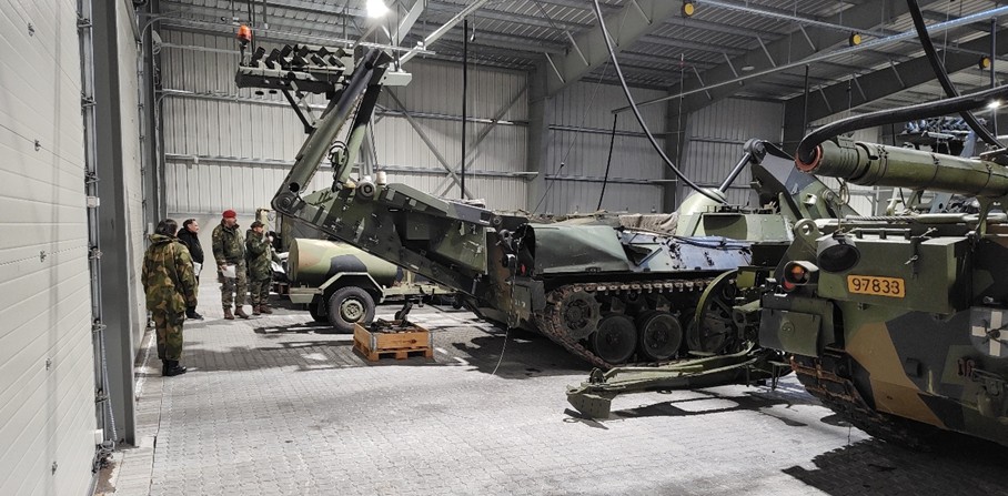 Team inspecting a “LEOPARD” bridge-laying vehicle
